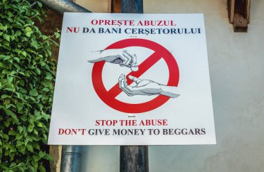 Sighisoara, Romania - July 4, 2016: Beggars warning sign in Sighisoara town clipart