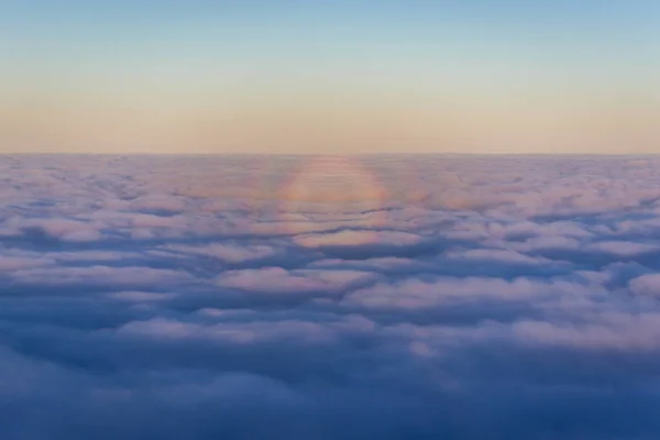 飛行機の窓から見える朝の雲の上の光現象 — ストック写真