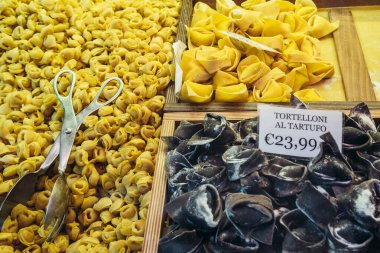 Variety of Tortelloni on covered food market Mercato di Mezzo in historic part of Bologna city, Italy clipart