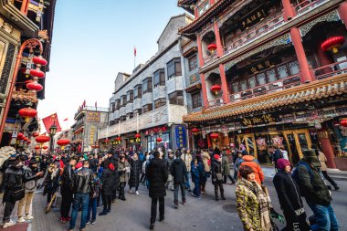 Beijing, China - February 8, 2019: People in Dashilan hutong, famous shopping street in Beijing city clipart