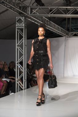 A model walks the runway for Designer Garry Desyin during FLL Fashion Week at the Huizenga Plaza in Fort Fort Lauderdale on March 17th, 2018 clipart