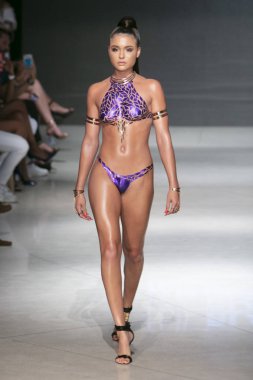 Kara Kaset Projesi Yaz 2019 koleksiyonunda, 15 Temmuz 2018 'de Miami' deki Faena Sahili 'nde Sanat, Kalpler ve Moda Yüzme 2018' de bir model podyumda yürüyor.