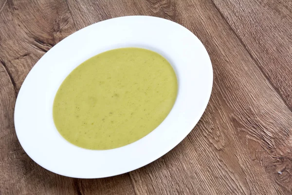 Vegetable soup on a wooden table — Stock Photo, Image