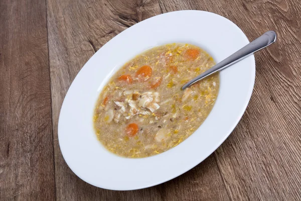 Vegetable soup on a wooden table — Stock Photo, Image