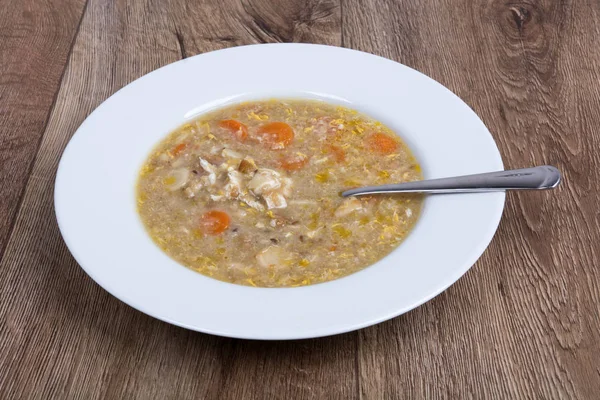 Vegetable soup on a wooden table — Stock Photo, Image