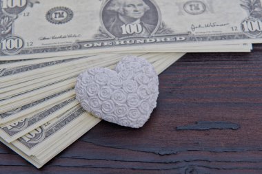 Doları banknot ve ahşap bir masa üzerinde kalp