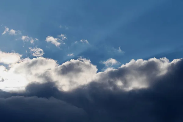Schöner Sonnenstrahl und bewölkt am blauen Himmel — Stockfoto