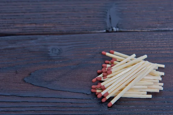 Matches with brown heads on a table — Stock Photo, Image