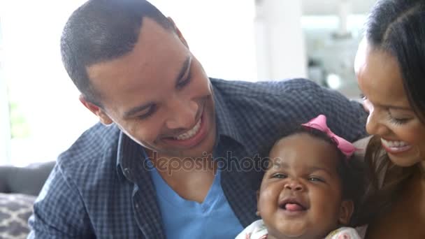 Parents Sitting On Sofa With Baby Daughter — Stock Video