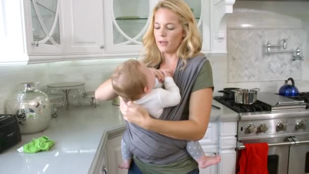 Busy Mother With Baby In Sling — Stock Video