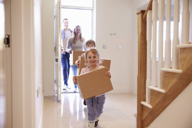 Family Carrying Boxes Into New Home  clipart