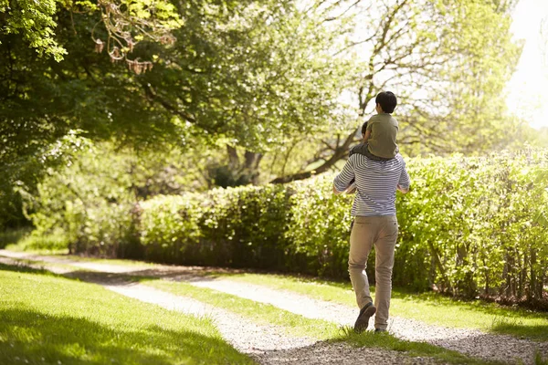 Padre dando hijo paseo en hombros —  Fotos de Stock