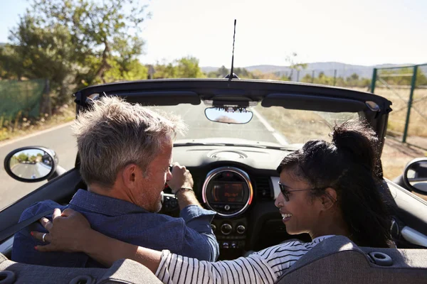 Couple driving in open top car — Stock Photo, Image