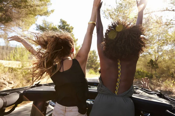 Vrouwen permanent aan de achterkant van auto — Stockfoto