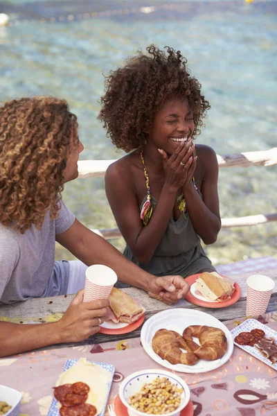 Couple eating at table by the sea — Stock Photo, Image