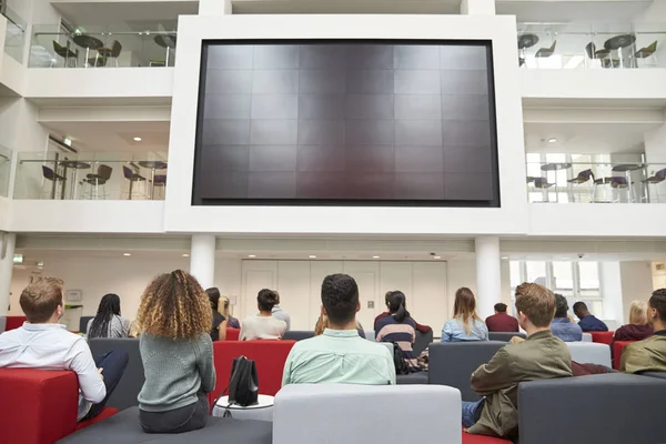 Students watching big screen in university — Stock Photo, Image