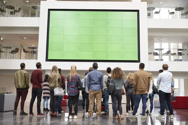 Students looking up at a big screen