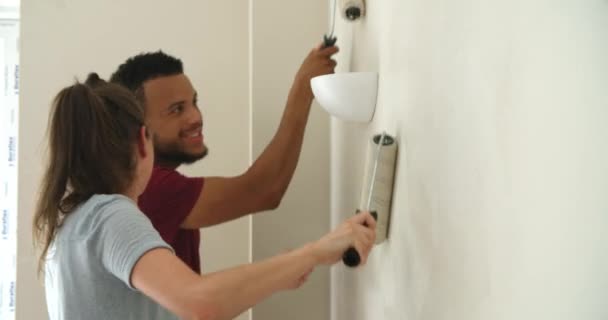 Pareja decorando casa con rodillos de pintura — Vídeos de Stock