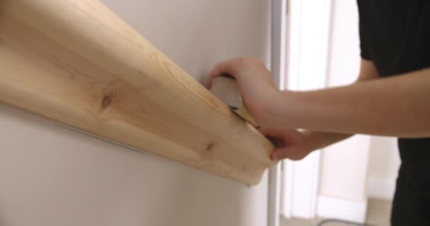 Hands sanding a wooden handrail — Stock Video