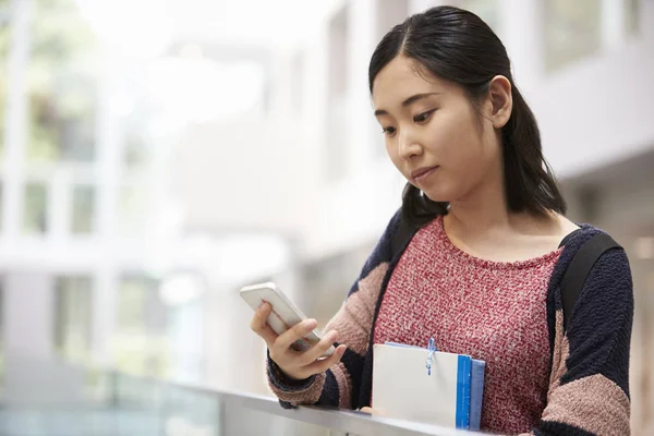 Asian student using smartphone Stock Image