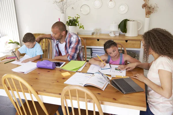 Parents sitting with children at table — Stock Photo, Image
