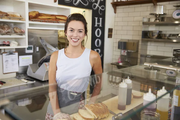 Female business owner behind counter — Stock Photo, Image