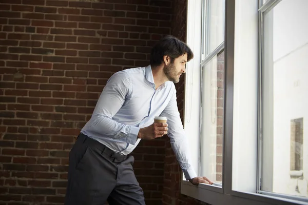 Businessman Standing By Window — Stock Photo, Image