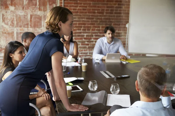 Woman leaning on table in Boardroom — Stock Photo, Image