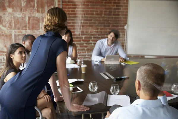 Woman leaning on table in Boardroom — Stock Photo, Image