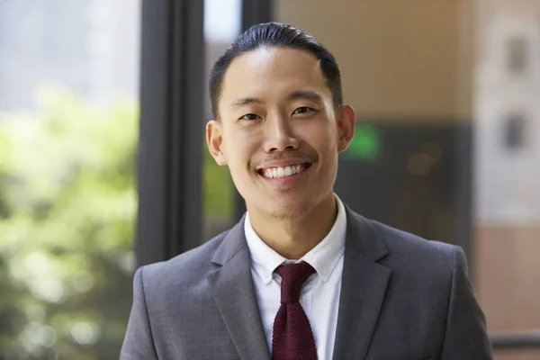 Asian businessman smiles — Stock Photo, Image