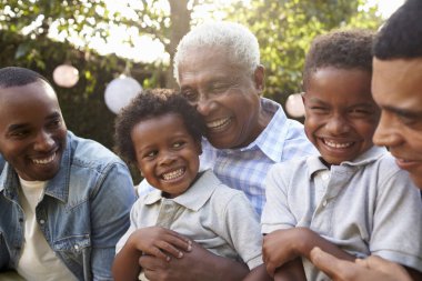 Senior man with sons and grandsons clipart