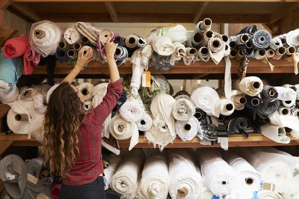 Young woman reaching to fabric — Stock Photo, Image