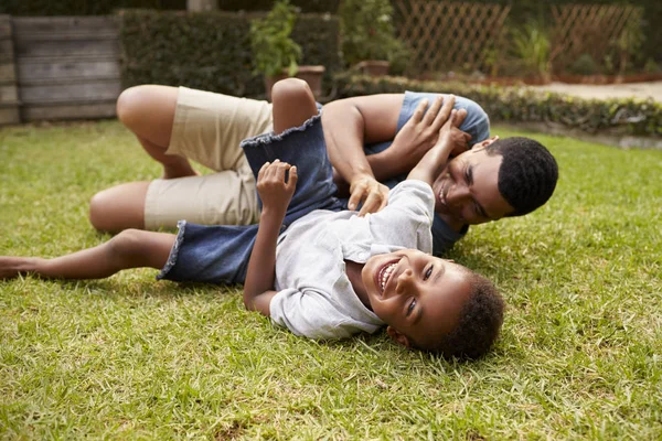 African american boy playing with dad