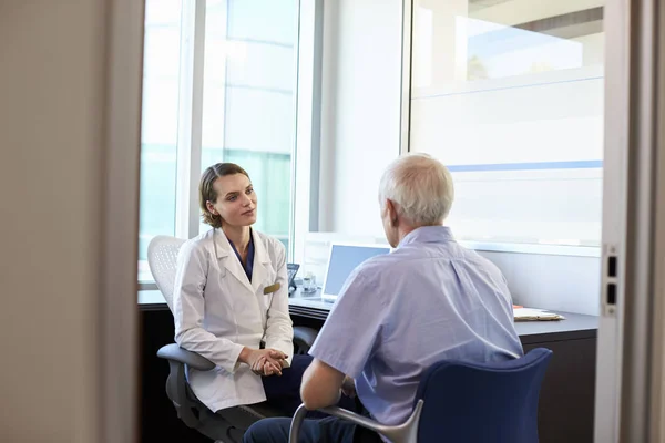 Médico femenino consultando paciente masculino — Foto de Stock