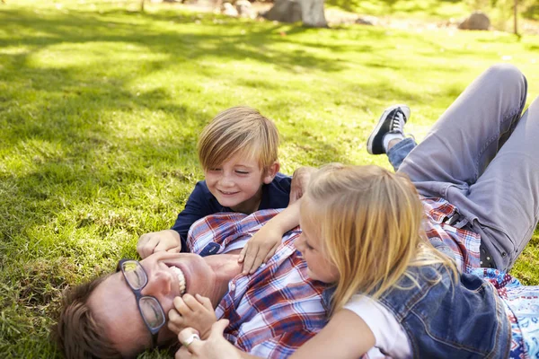 Niños jugando con papá — Foto de Stock