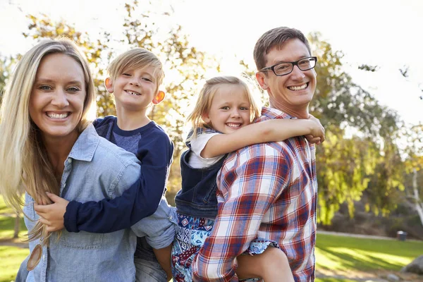 Parents carrying young kids — Stock Photo, Image