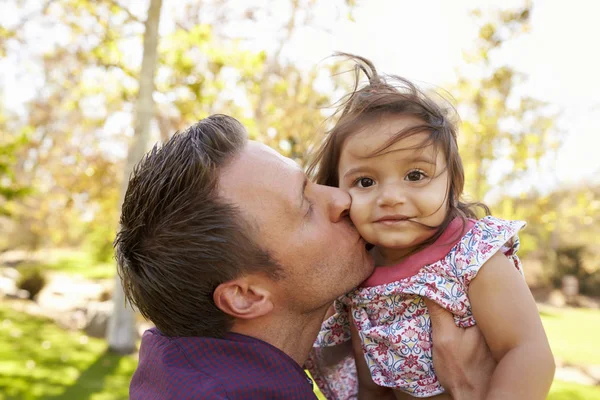 Father holding and kissing daughter — Stock Photo, Image