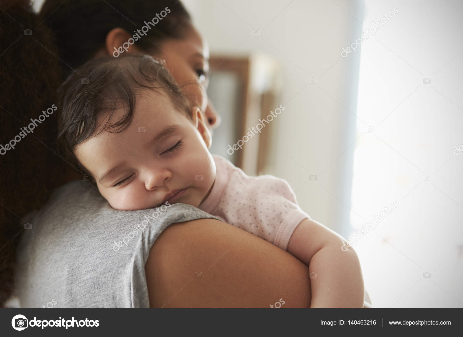 Mother Cuddling Sleeping Baby — Stock Photo © monkeybusiness 140463216