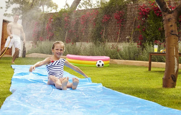 Father On Water Slide In Garden — Stock Photo, Image
