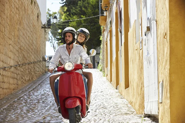 Couple riding motor scooter — Stock Photo, Image