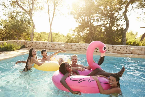 Jovens amigos se divertindo na piscina — Fotografia de Stock
