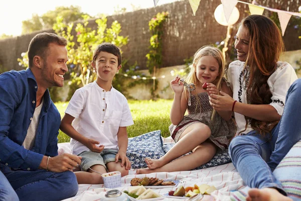 Family enjoying backyard picnic