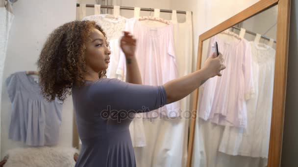 Woman taking selfie in changing room — Stock Video