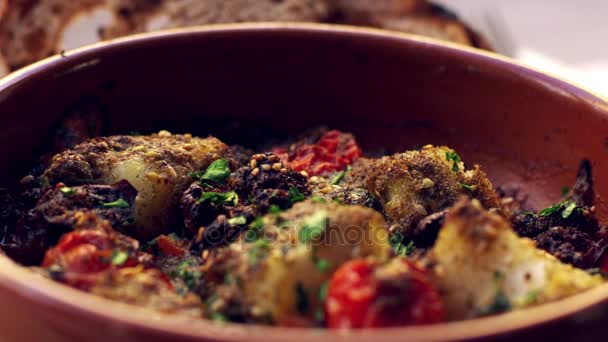 Cod and chorizo bake in earthenware dish — Stock Video