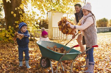 Children Helping Parents To Collect Leaves  clipart