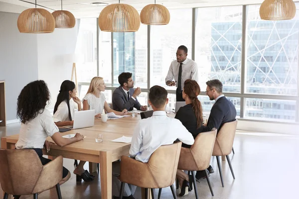 Businessman Stands To Address Meeting — Stock Photo, Image