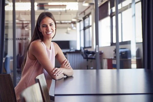 Young woman sitting in boardroom — Stock Photo, Image