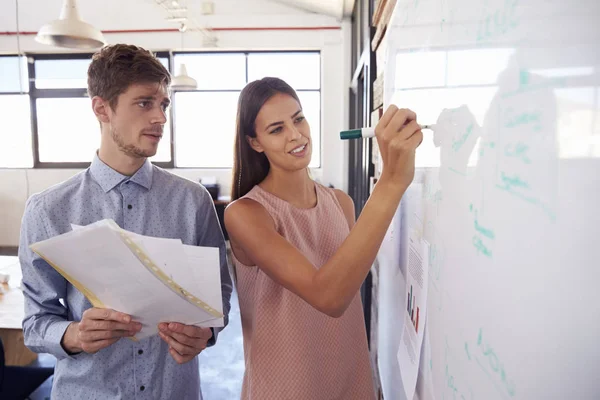 Young man and woman making notes — Stock Photo, Image