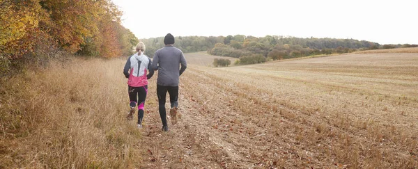 Mature Couple Running Around Field — Stock Photo, Image