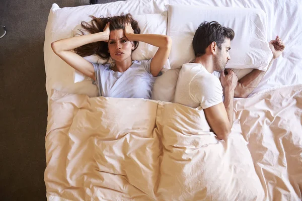 Couple lying in bed — Stock Photo, Image